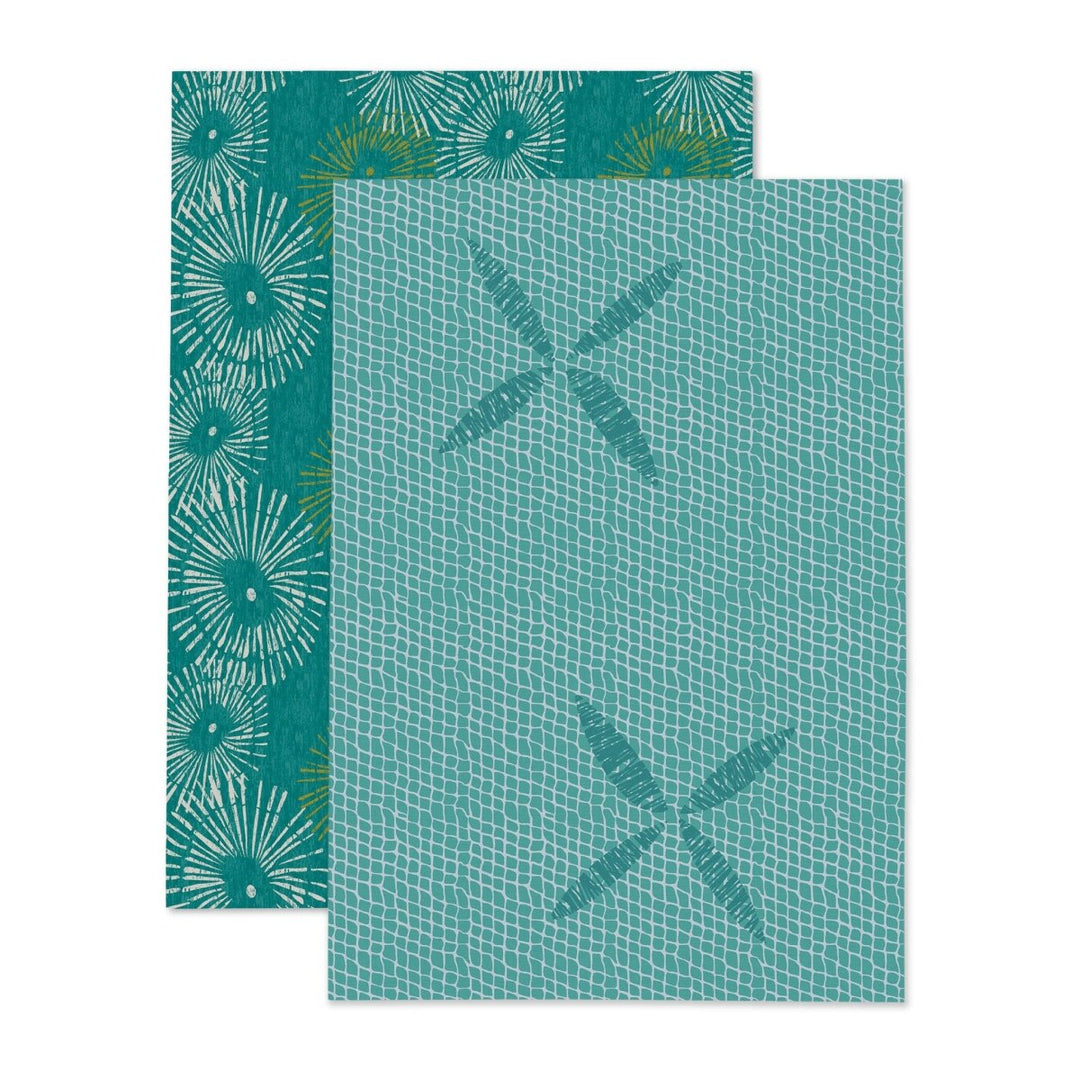 Two teal patterned towels on a white background