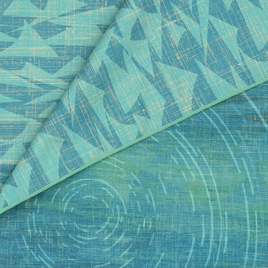 Close-up of Kilo Hōkū Microfiber Beach Towel front and back design (front - celestial night sky, back - ocean waves)