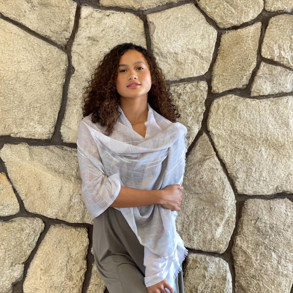 model wearing kilo hoku travel wrap in front of rock wall