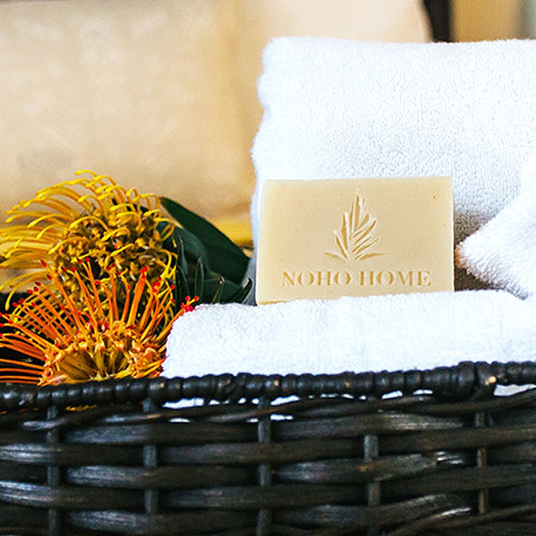 soap in basket with towels and pincushion flowers