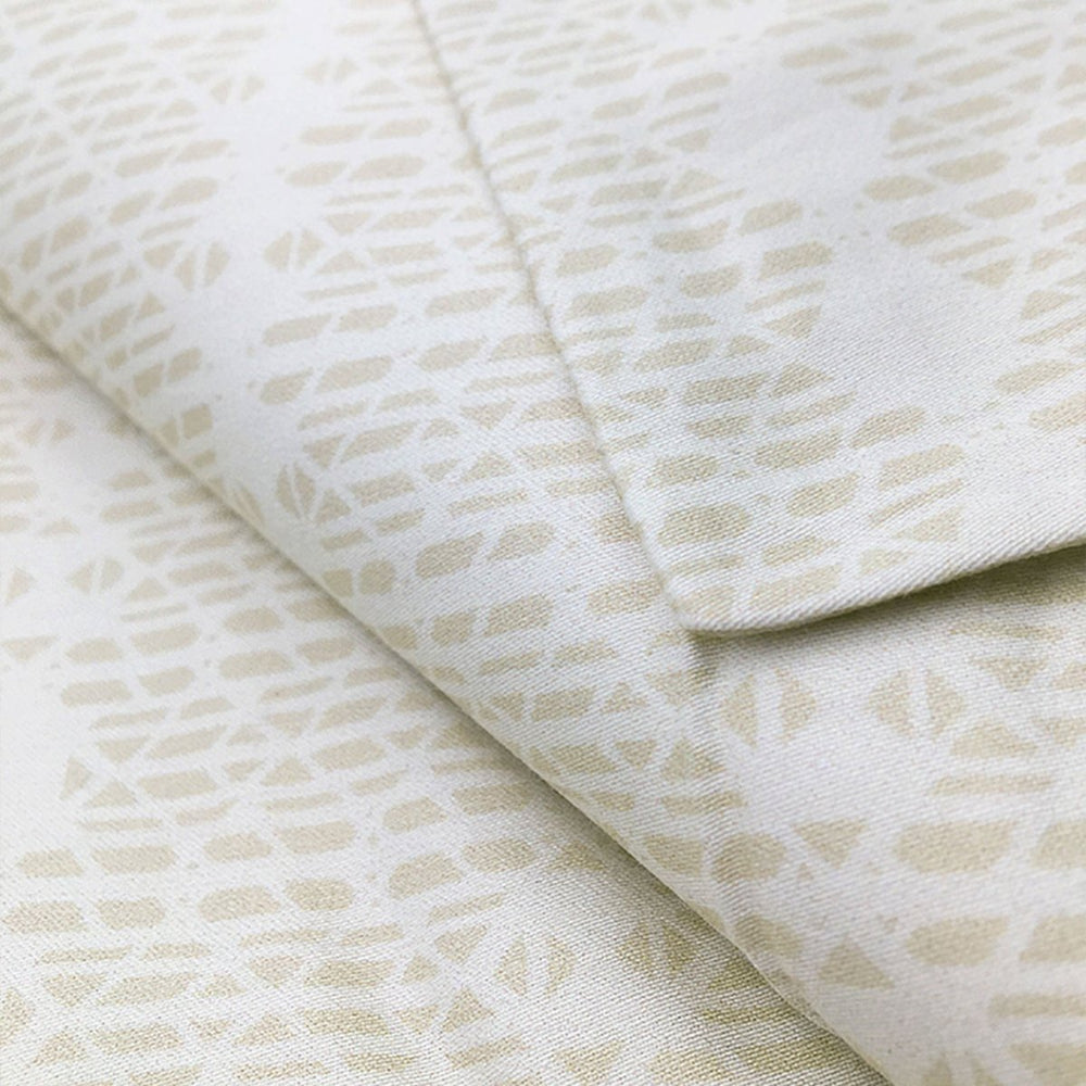 Close view of the cream Kua print on a NOHO HOME bed pillowcase