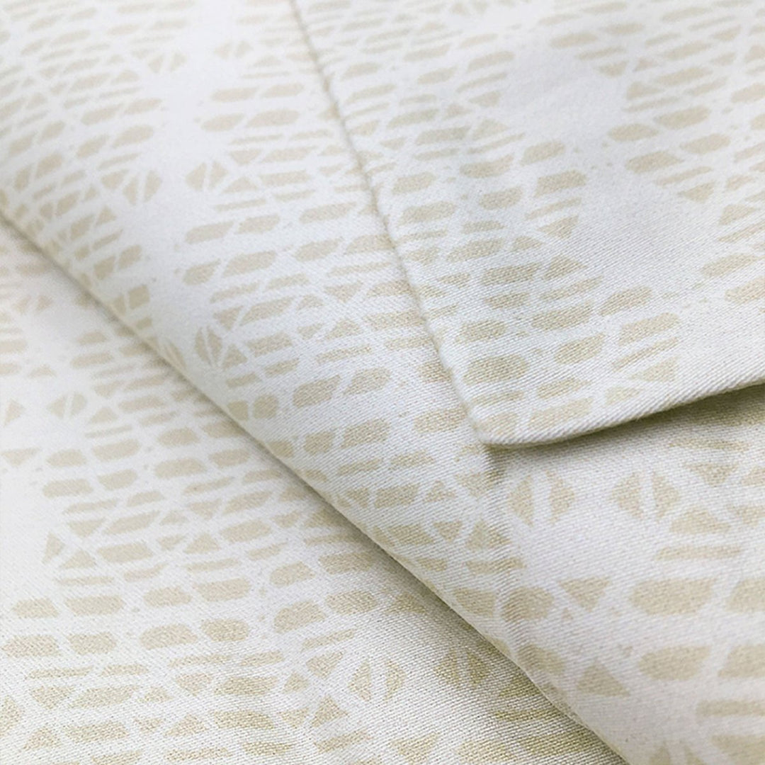 Close view of the cream Kua print on a NOHO HOME bed pillowcase