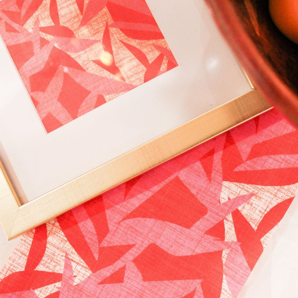 Lele Art Print framed with gold trim resting on Lele fabric