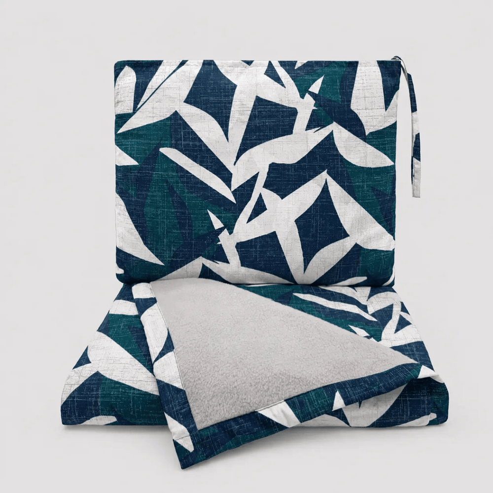 Lele Travel Blanket in Twilight, folded into its wristlet — Native Hawaiian ʻiwa bird pattern by NOHO HOME.