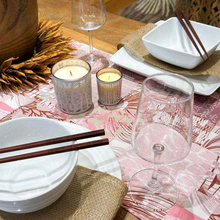 Pink Maui Strong Table Runner on table with candles, plates, water glass and candles.