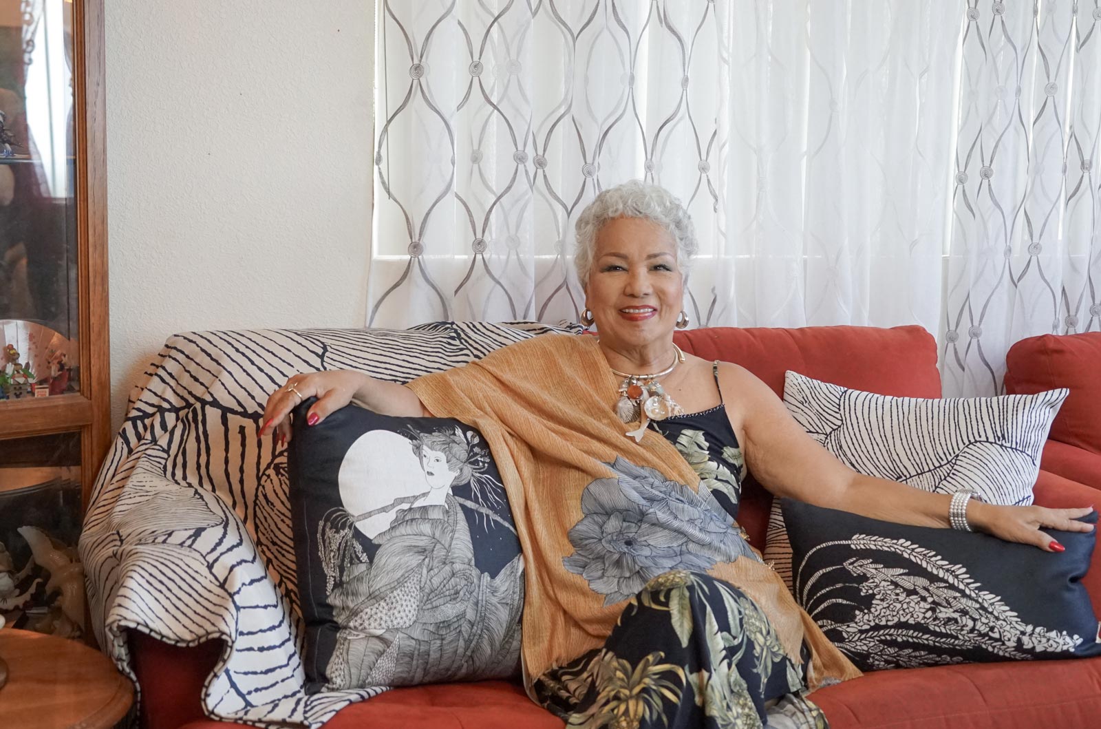 Indigenous Hawaiian Singer Melveen Leed Sitting on a Couch with Décor Pillows