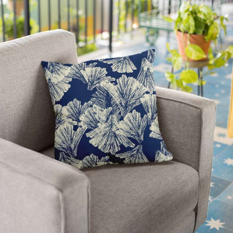 image of blue floral pillow on chair outdoor