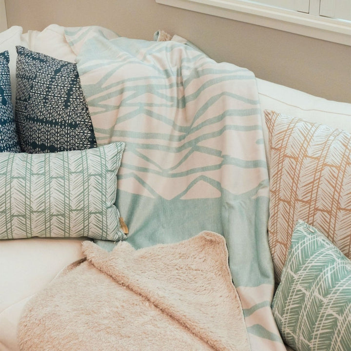 niho kila seafoam blanket staged on couch