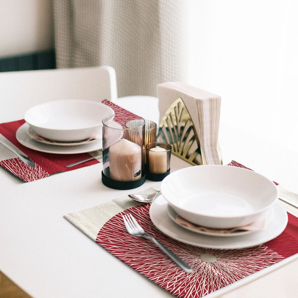Duo place setting utilizing the Red Niho Medallion Placemat Set, with cutlery and white bowls and plates