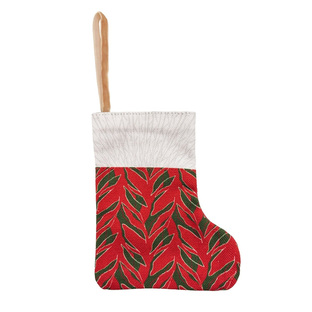 Front of the Kī mini stocking: red ti-leaf print with a natural cuff and satin loop