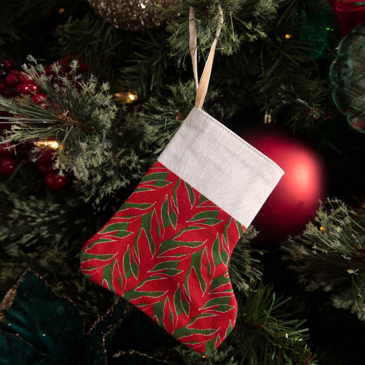 Kī print mini stocking hanging on a holiday tree