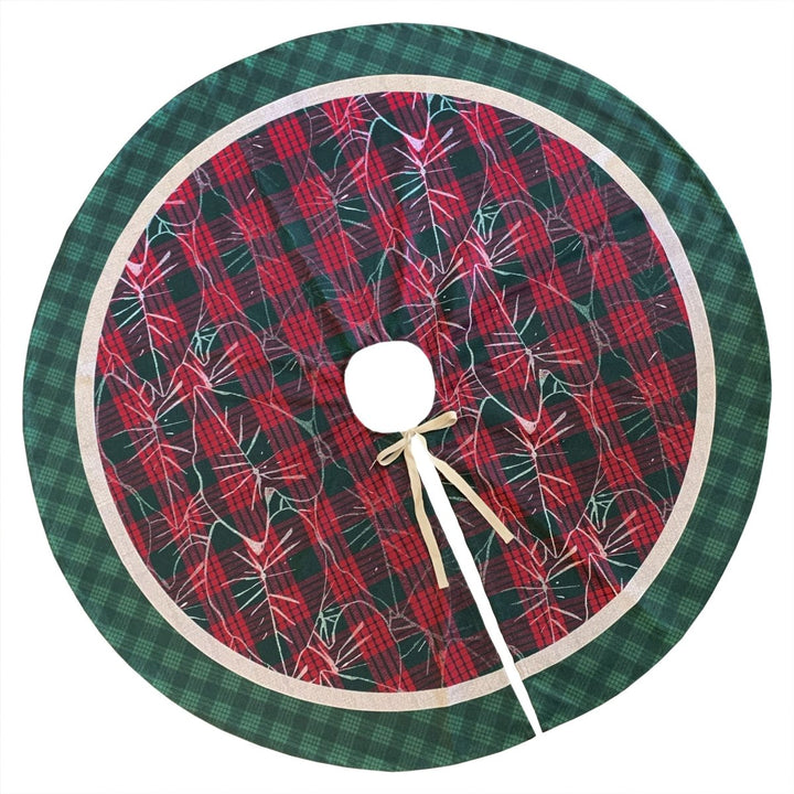Red and green plaid Christmas tree skirt with a white bow on a white background