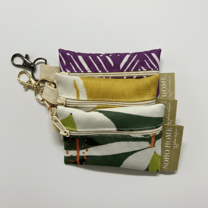 Set of fabric pouches with colorful patterns on a white background