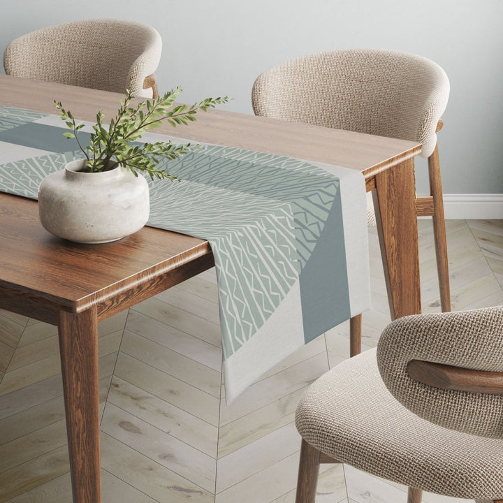 Blue Niho Medallion table runner adorned on wooden table.