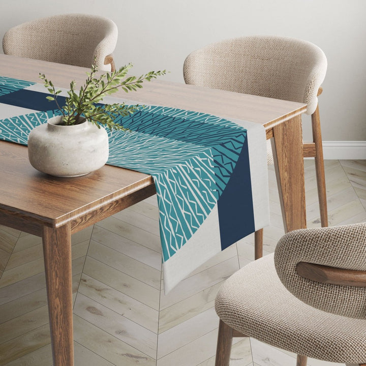 Blue Niho Medallion table runner adorned on wooden table.