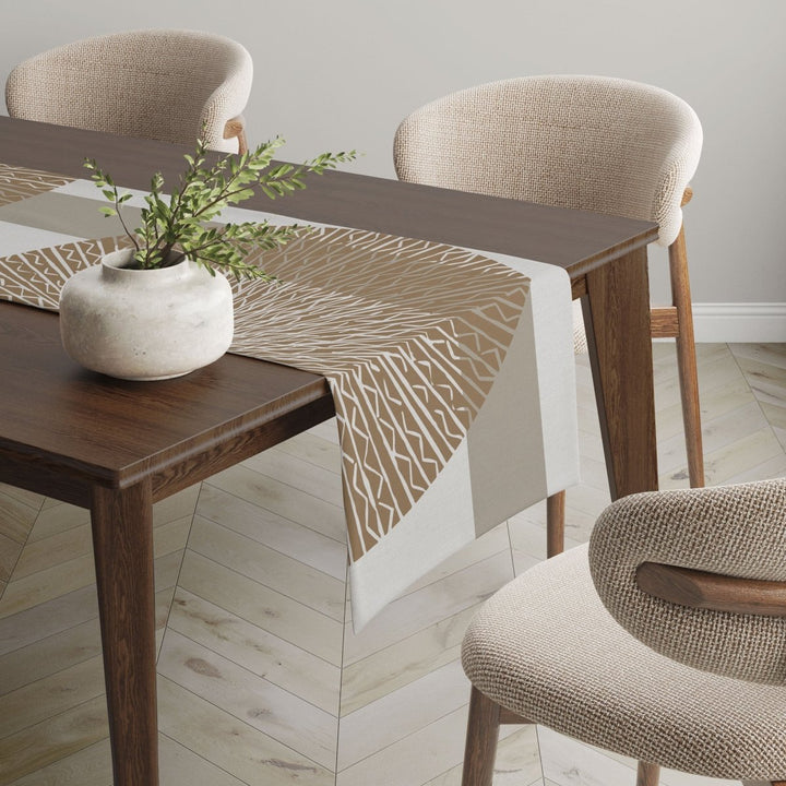 Gold Niho Medallion table runner adorned on wooden table.