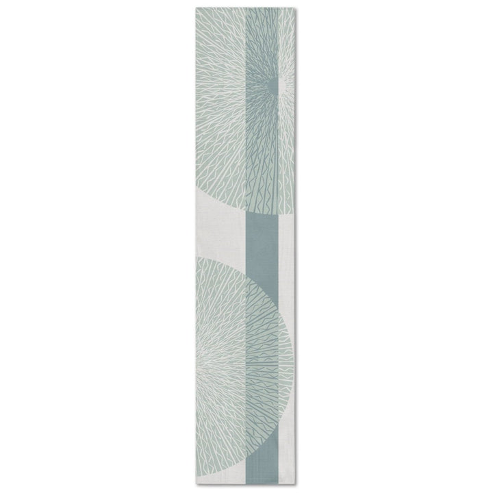 A rectangular table runner with a white background and blue medallion pattern.