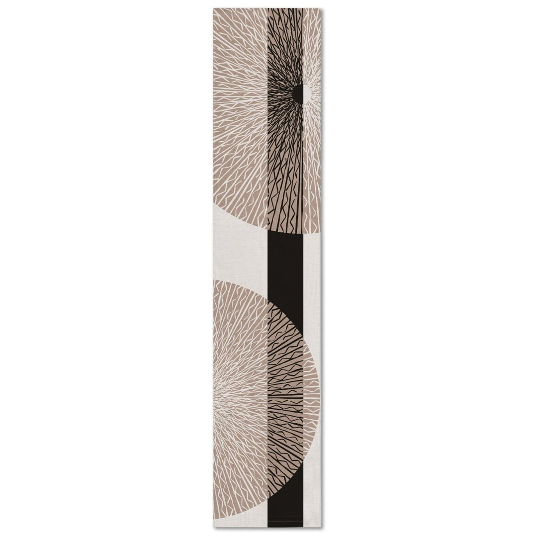 A rectangular table runner with a white background and black medallion pattern.