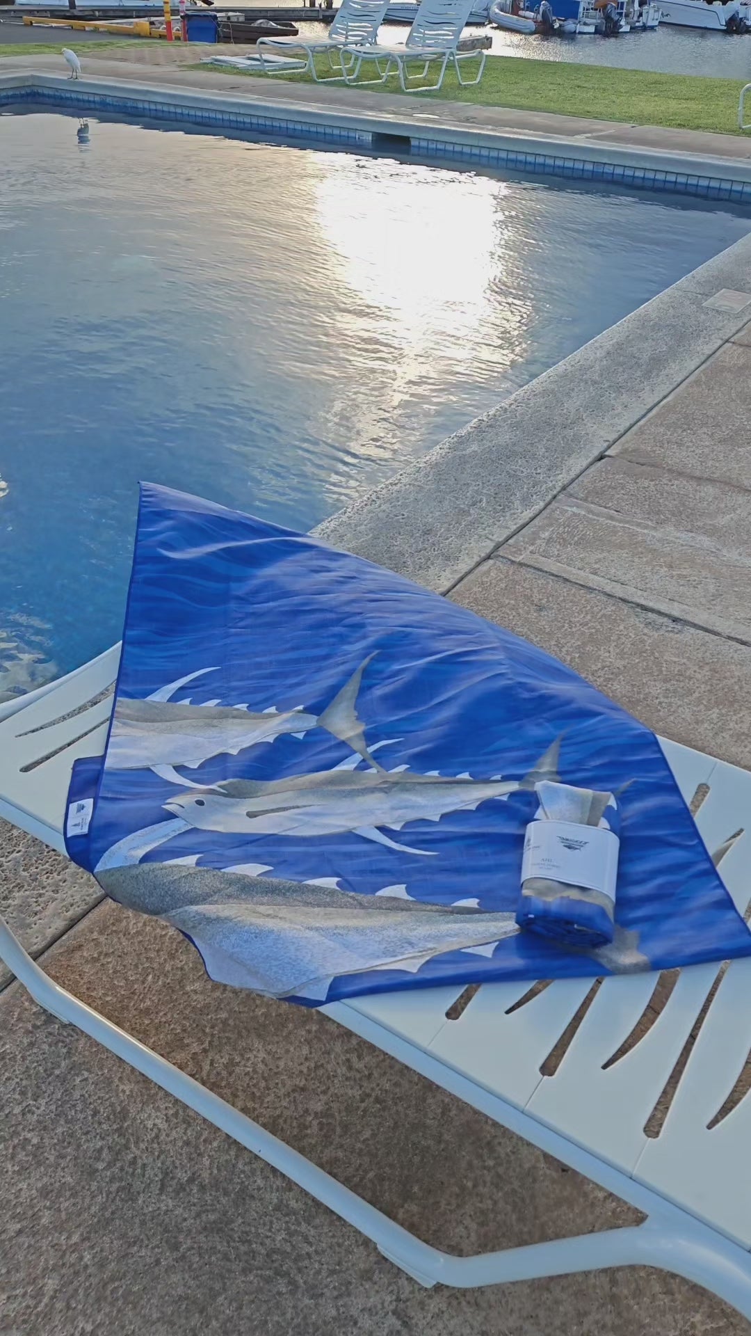 blue microfiber travel towel with ahi fish print on chair by pool video