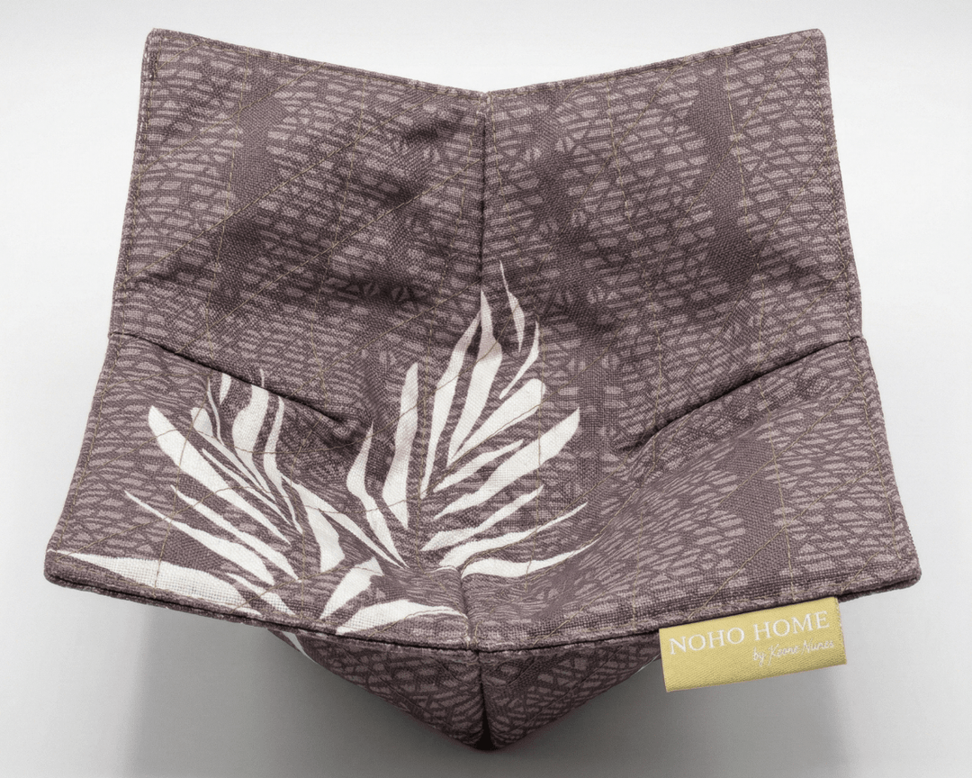 bowl cozy with leaf pattern and 'Noho Home' label on a white background