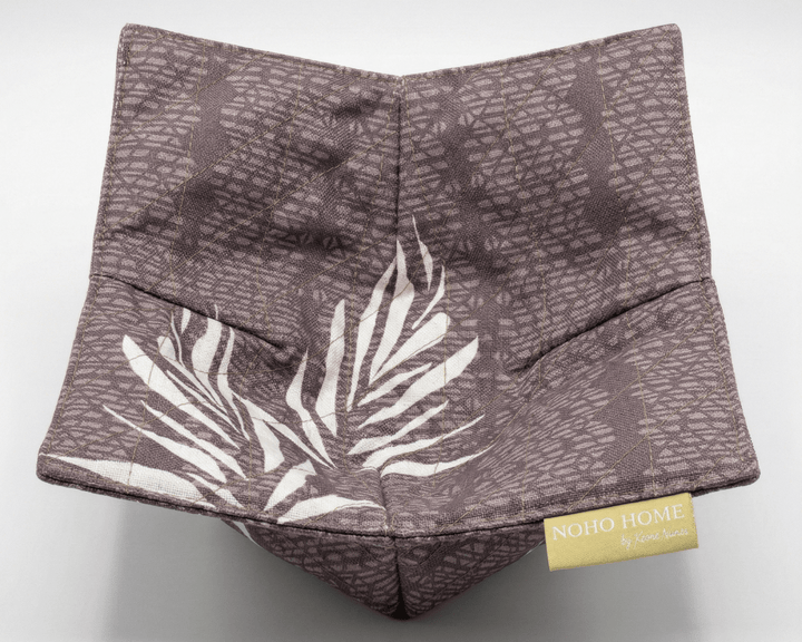 bowl cozy with leaf pattern and 'Noho Home' label on a white background