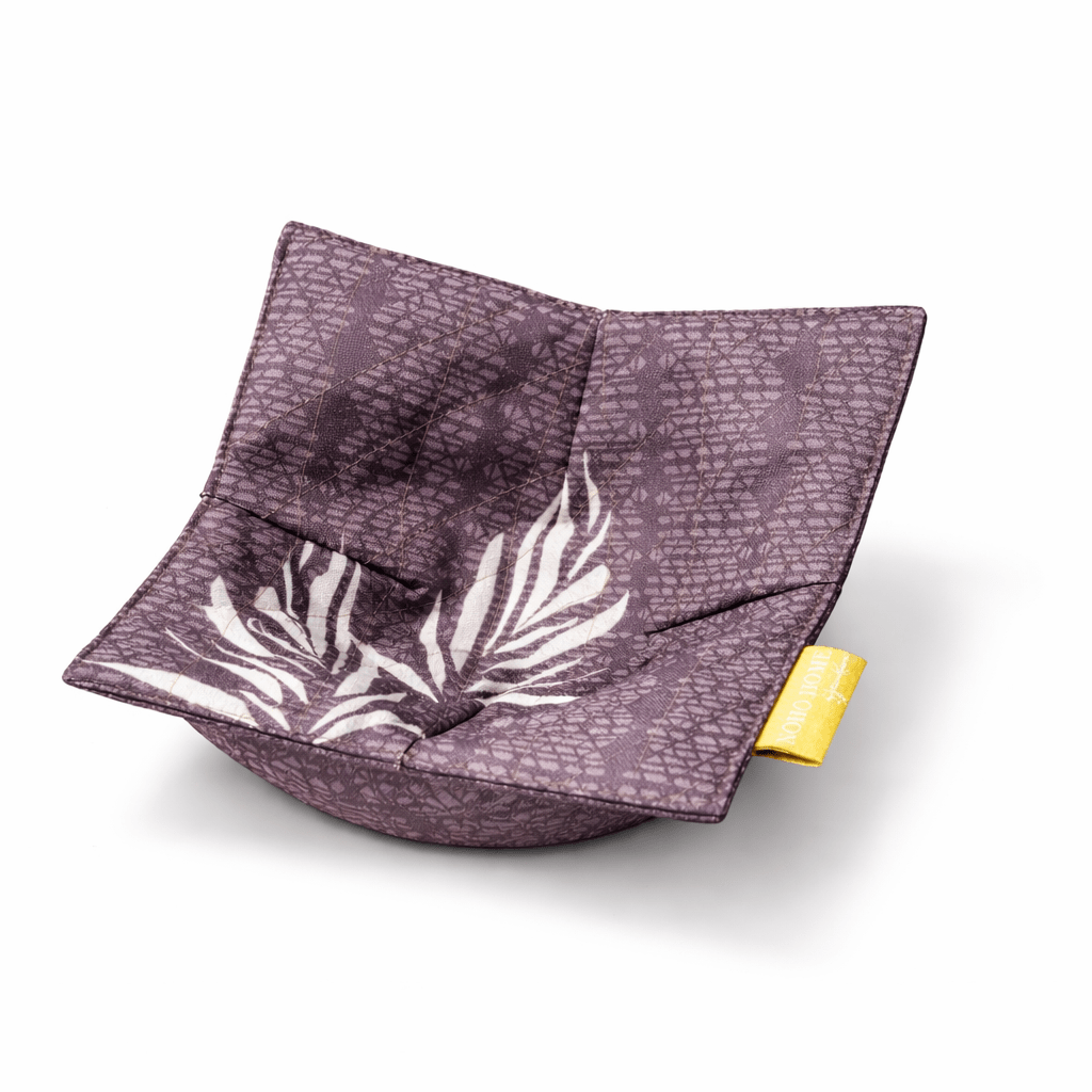 brown fabric bowl with white leaf pattern and yellow tag on a white background