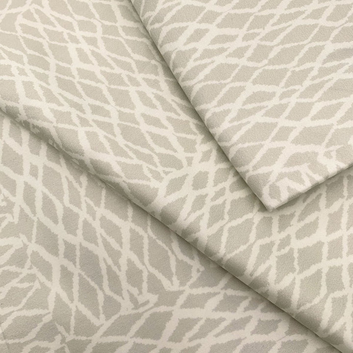 Close view of the white ʻUpena fishnet print on a NOHO HOME bed pillowcase