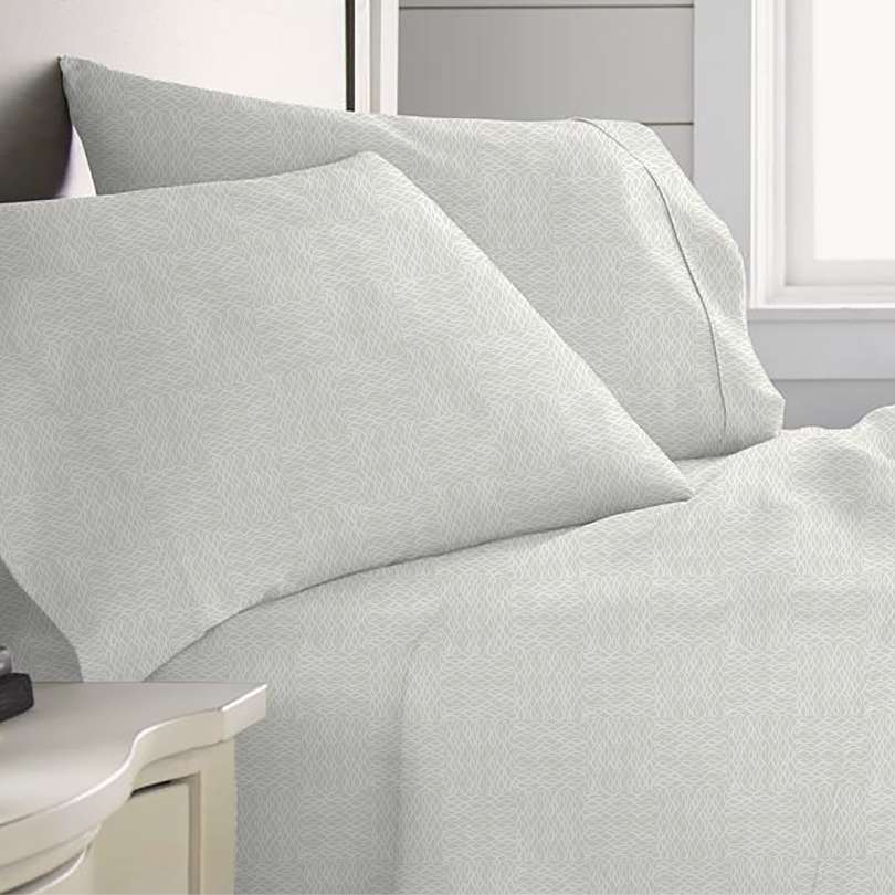 image of upena huli sheet sets light colored on bed