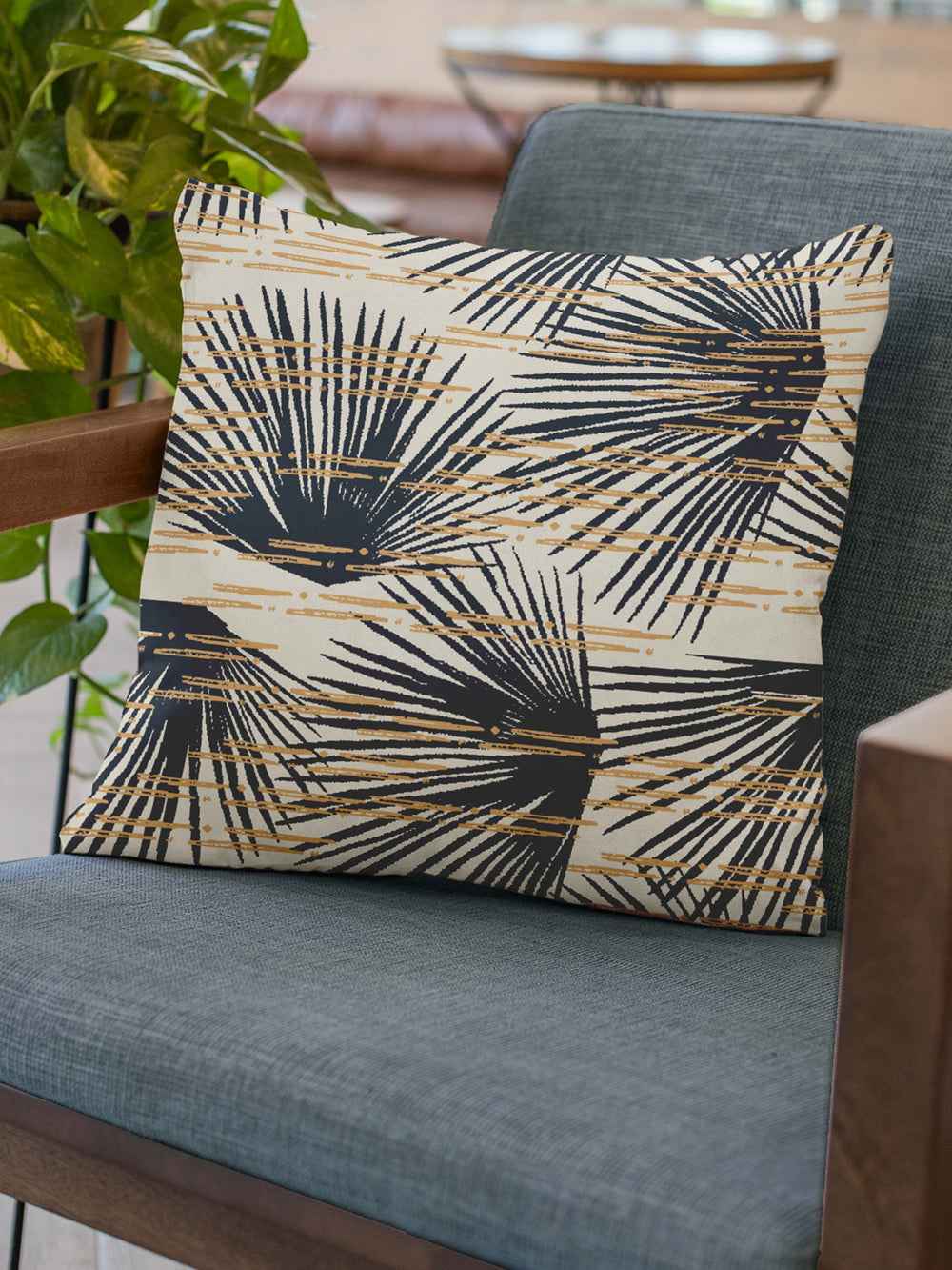 Midnight and Ivory Loulu Square Pillow Set On a Blue Grey Chair With Wood Arms