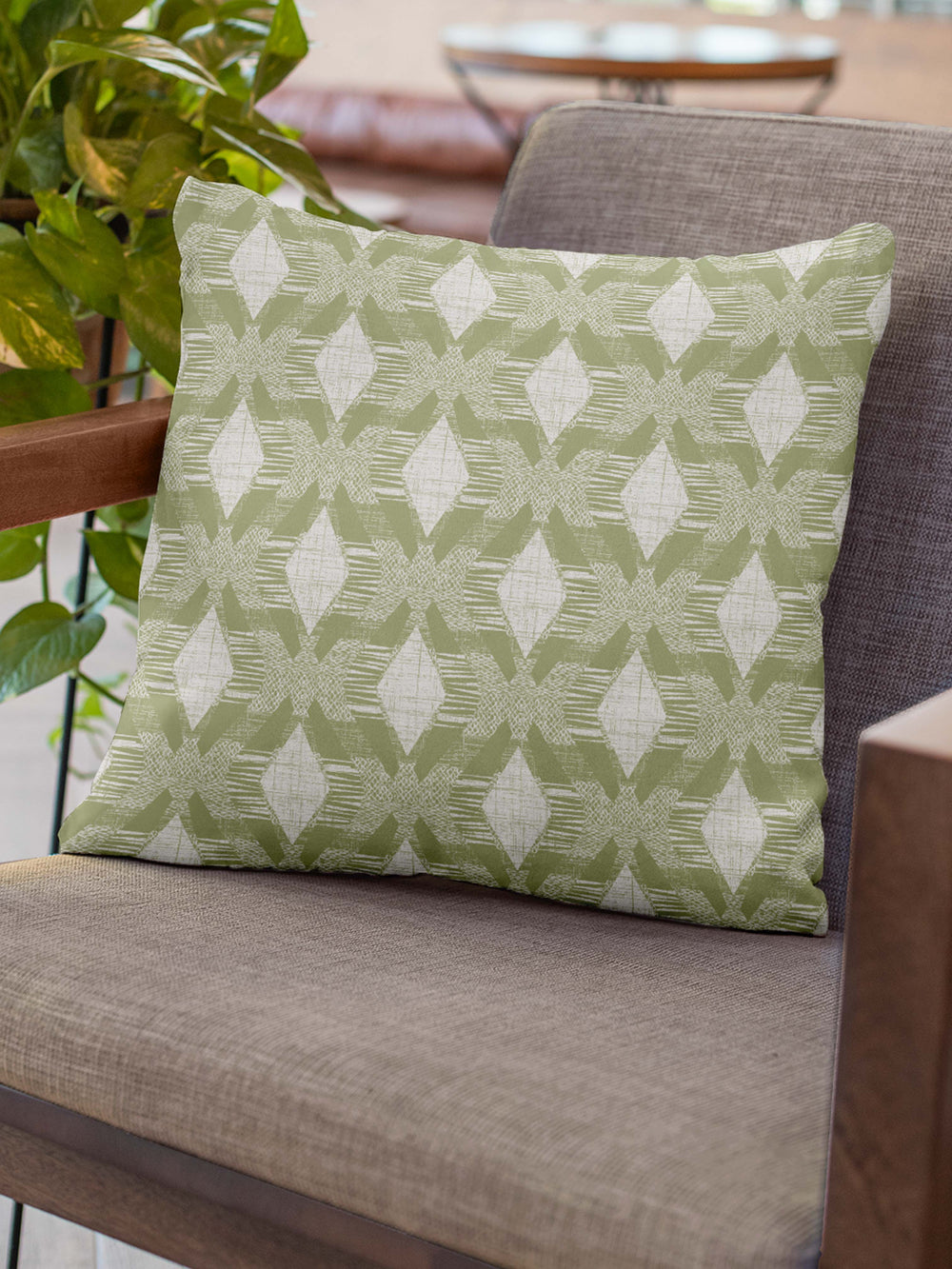 Spring Green Color Kāholo Square Pillowcase Placed On a Chair With Wooden Arms