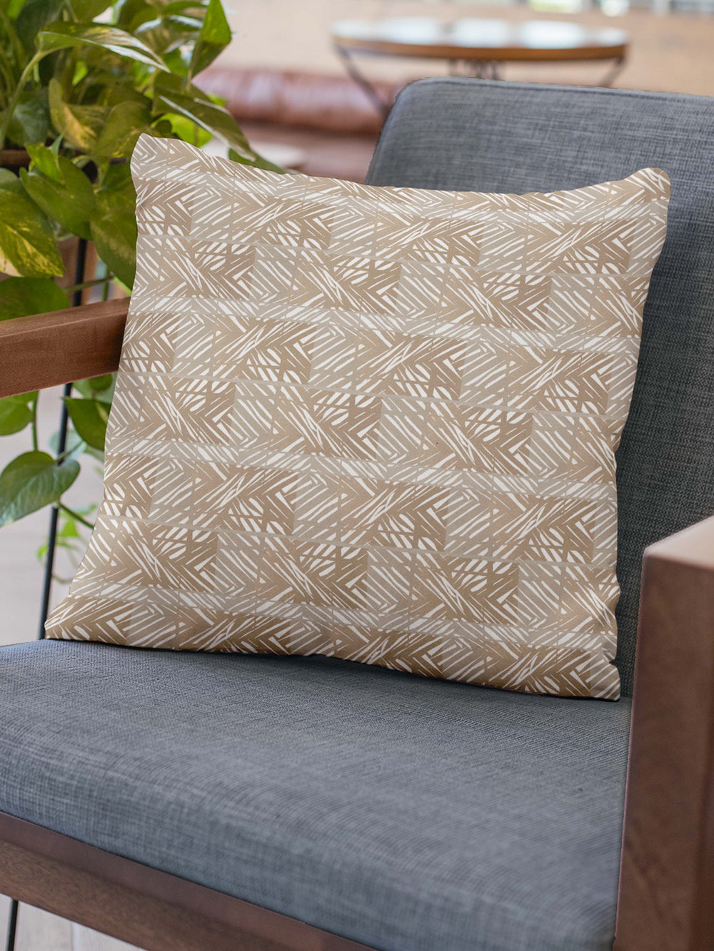 Moena Nui Square Pillowcase Set On a Blue Grey Chair With Wood Arms 