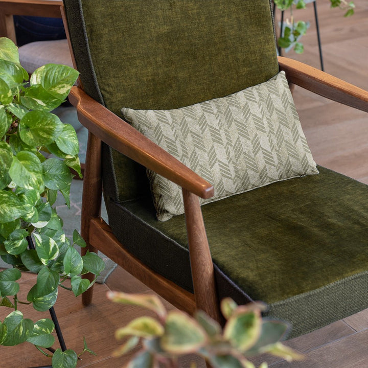 Taupe & Ivory Kapa Hou Lumbar Pillowcase placed on a olive chair with plant on the side