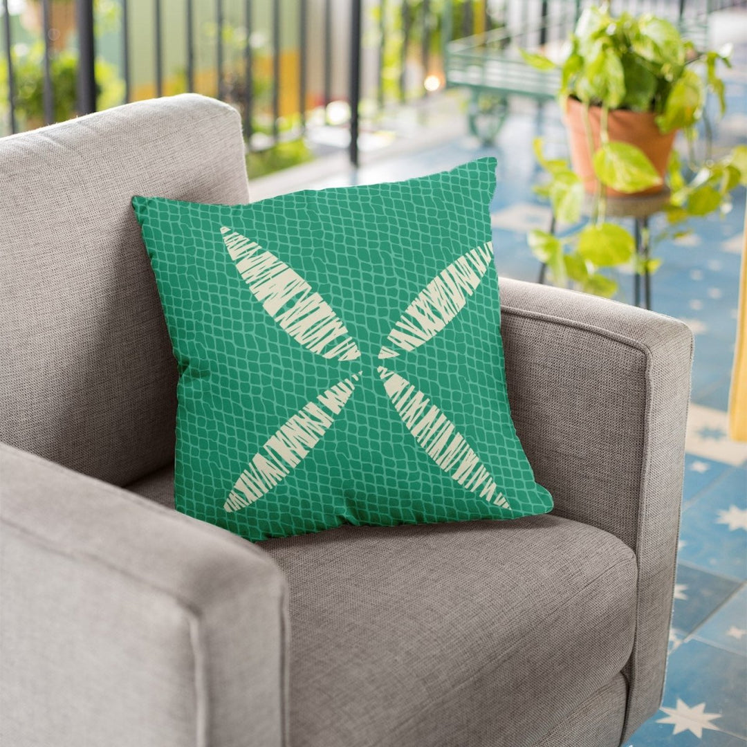 Ivory and Teal Kapua Kai Square Pillowcase Set On a Grey Chair Outside
