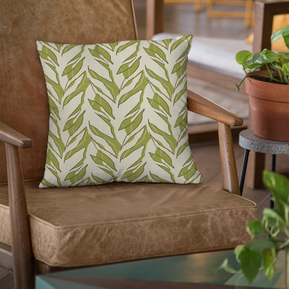 Moss and Ivory Kī Square Pillowcase Placed On a Weathered Lather Chair