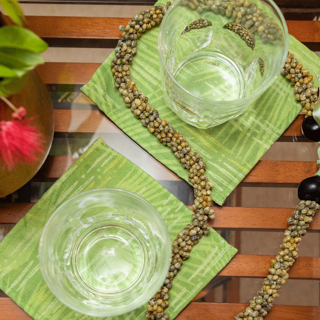 Green Loulu Cocktail Napkin Set accented with shell and kukui nut lei