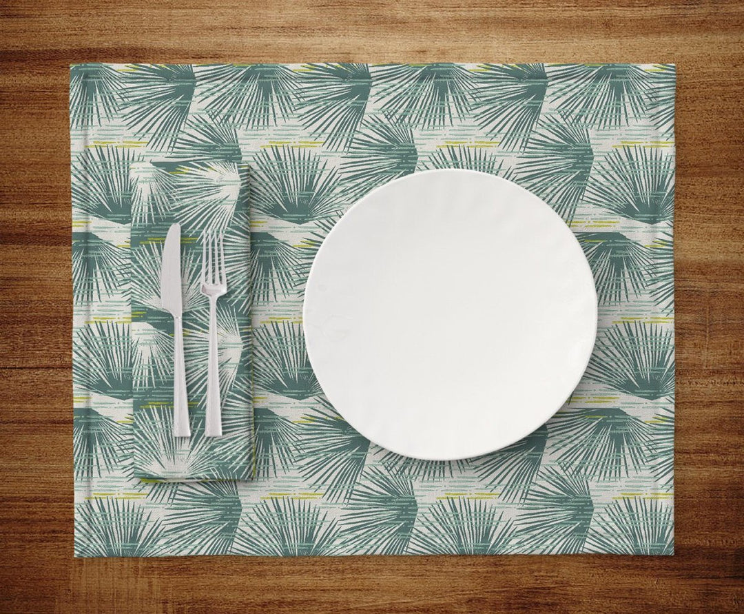 Table setting of plate, silverware, napkin and Blue and Ivory Loulu Dining Placemat Set