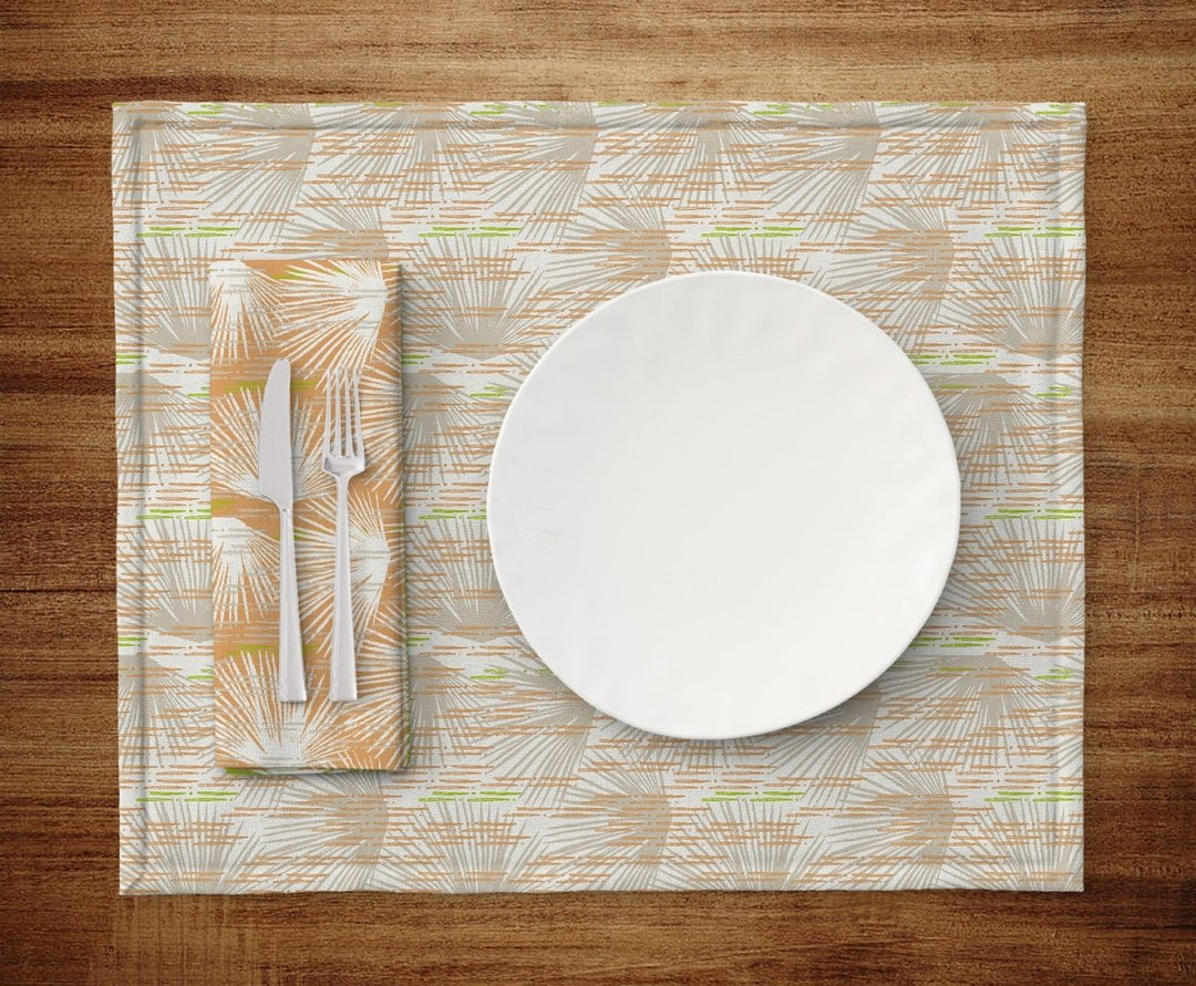 Table setting of plate, silverware, napkin and Orange and Ivory Loulu Dining Placemat Set