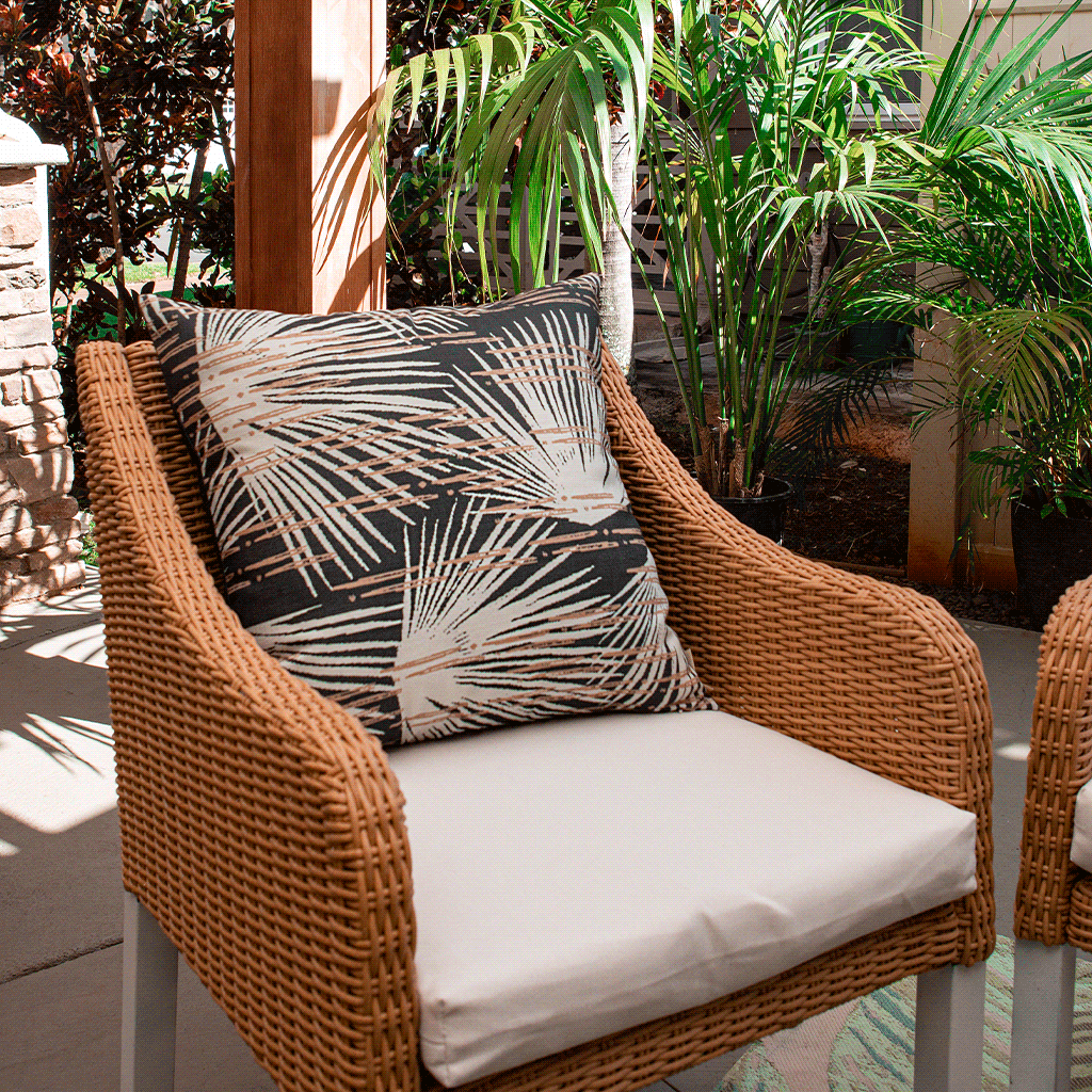 Dusk Loulu Square Pillow Set On a Wicker Chair With a Cream Seat Cushion