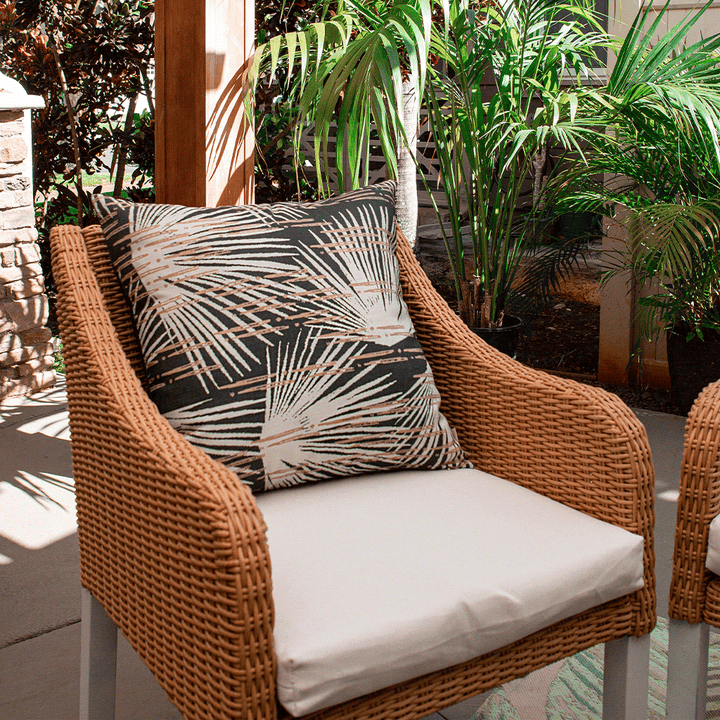 Dusk Loulu Square Pillow Set On a Wicker Chair With a Cream Seat Cushion