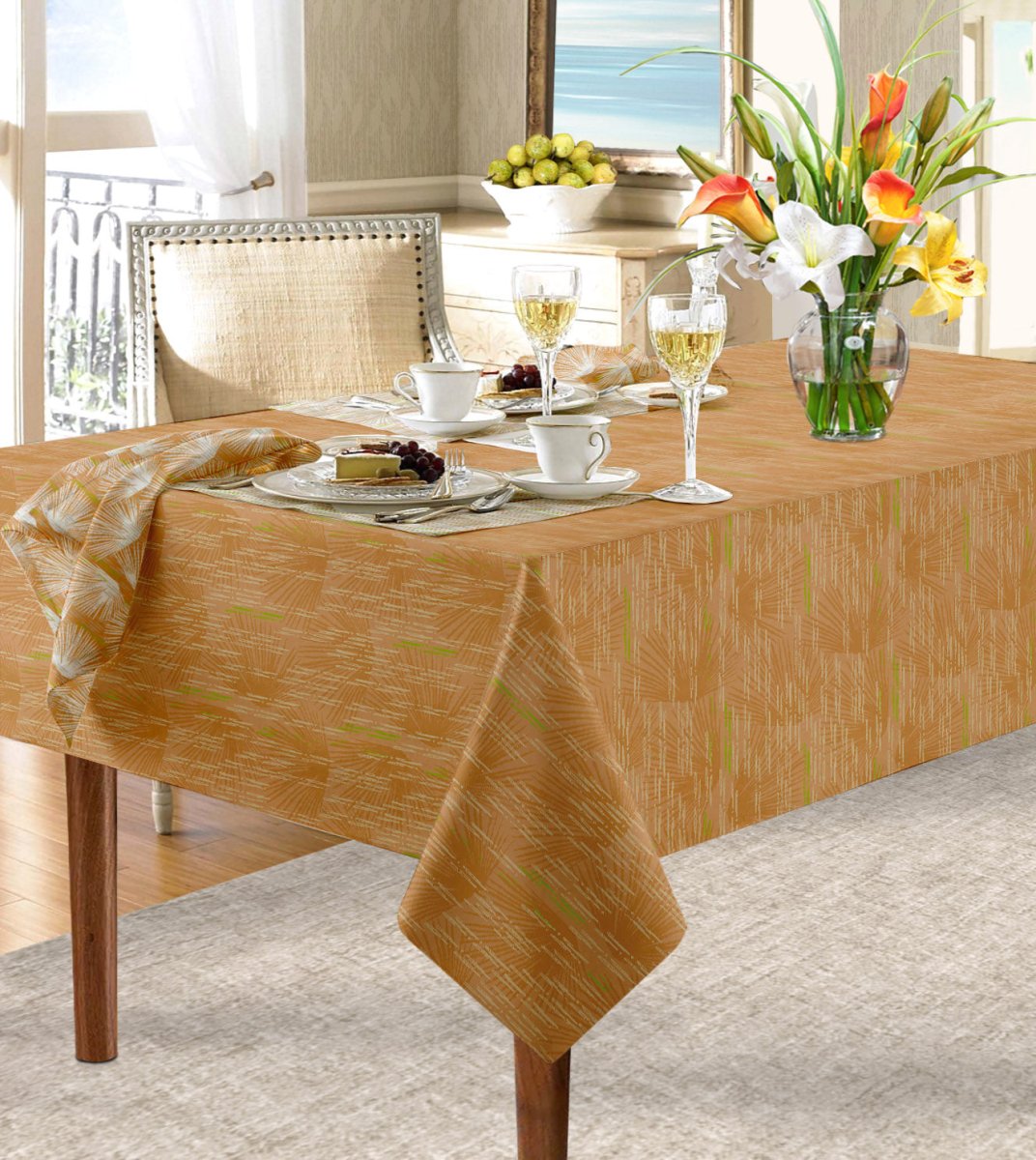 Orange Loulu Tablecloth draped over table paired with Loulu napkin.  Floral arrangement, wine glasses, cups and saucers and place settings complete the look.