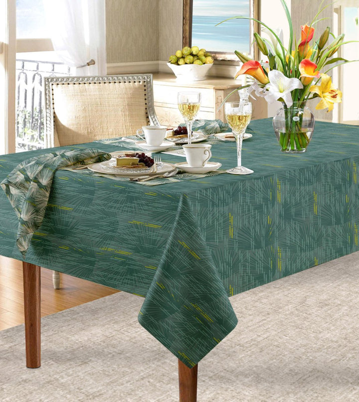 Blue Loulu Tablecloth draped over table paired with Loulu napkin.  Floral arrangement, wine glasses, cups and saucers and place settings complete the look.