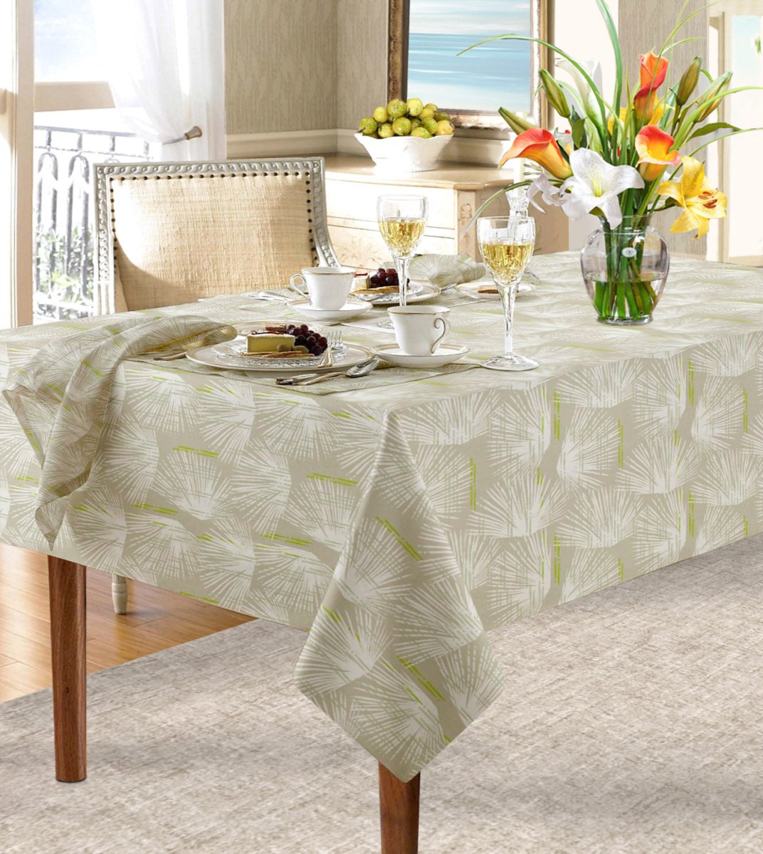 Ivory and Beige  Loulu Tablecloth draped over table paired with Loulu napkin.  Floral arrangement, wine glasses, cups and saucers and place settings complete the look.