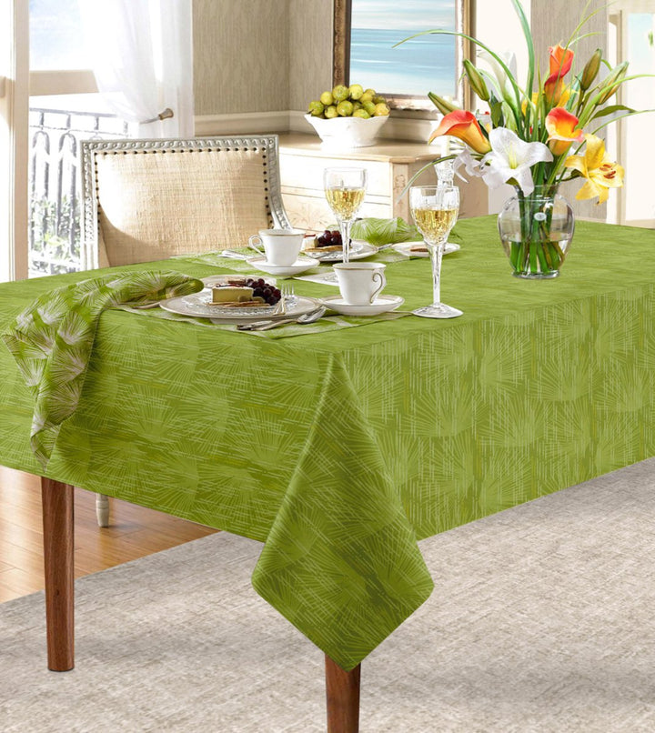 Green Loulu Tablecloth draped over table paired with Loulu napkin.  Floral arrangement, wine glasses, cups and saucers and place settings complete the look.