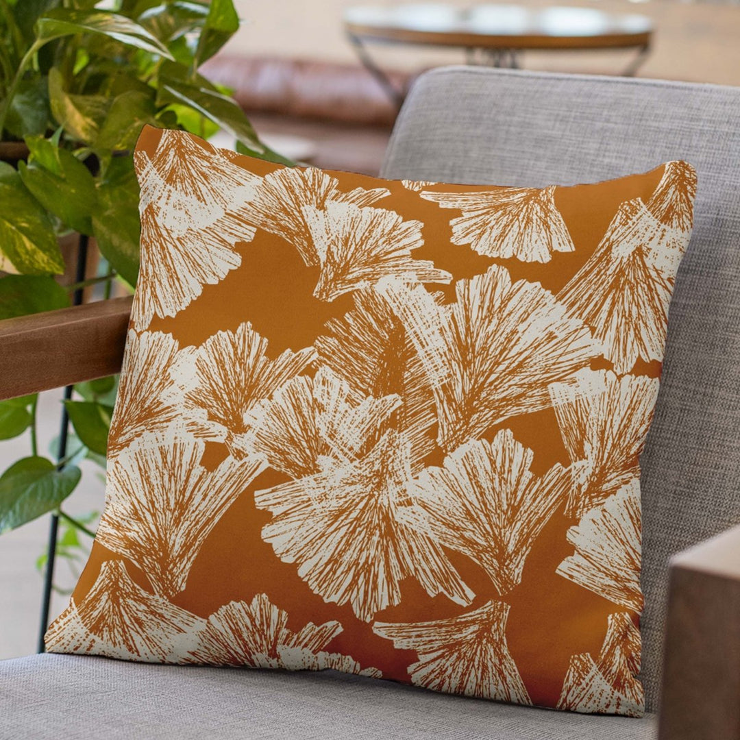 Tangerine Nahenahe Square Pillowcase Set On a Grey Chair with Wood Arms