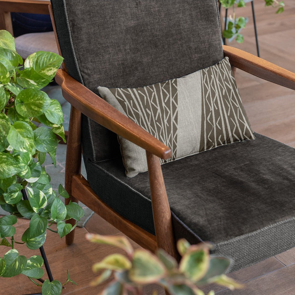Stone & Light Gray Niho Kila Lumbar Pillowcase on a dark drey chair