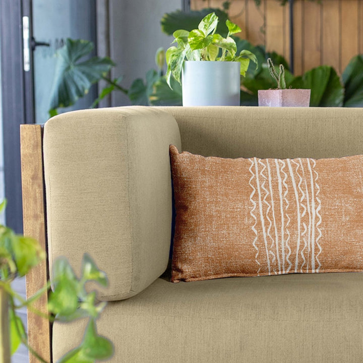 Tangerine Niho Lumbar Pillowcase Set On a Beige Colored Fabric Modern Sofa