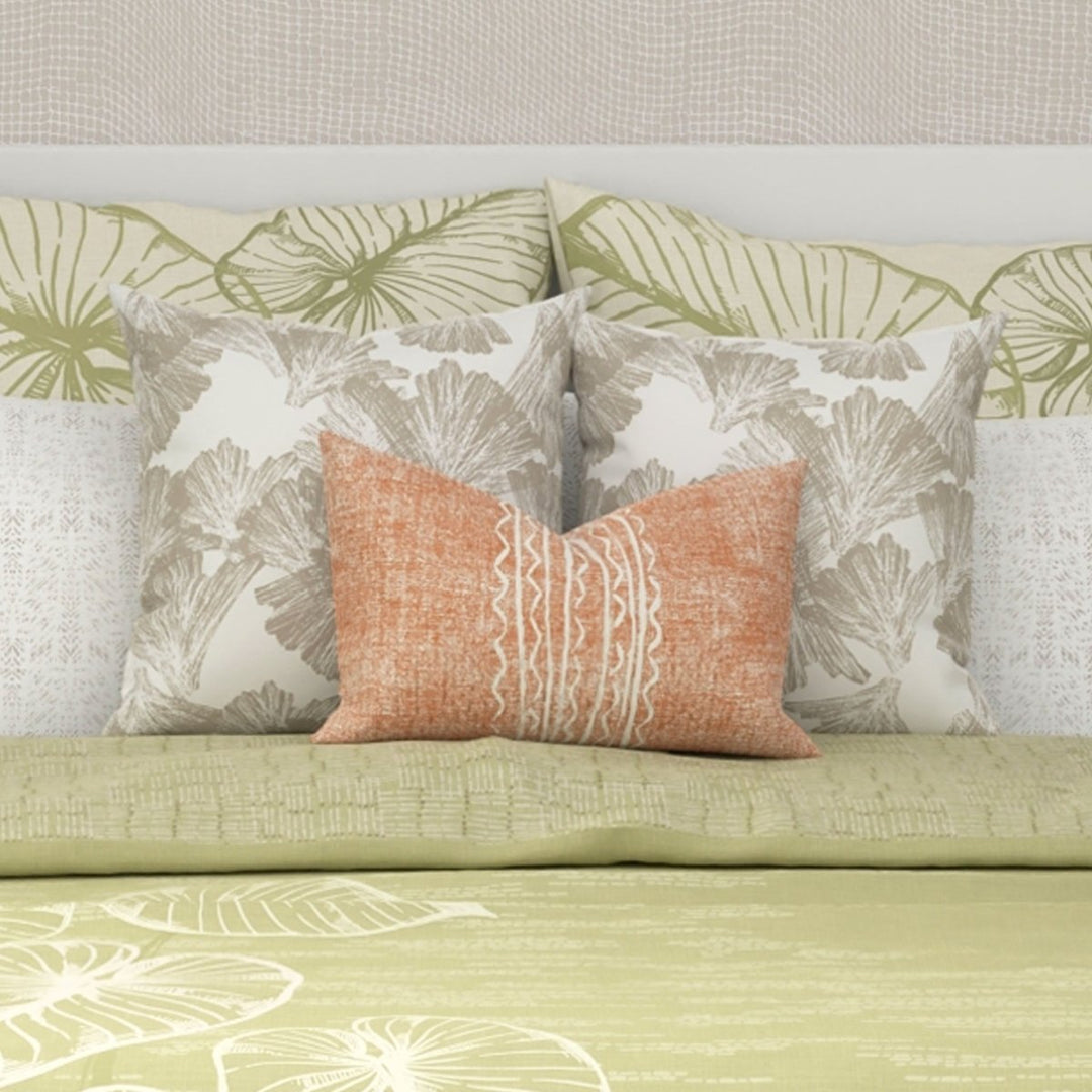 Tangerine Niho Lumbar Pillowcase Set On a King Size Bed With 2 Square Pillows Behind It