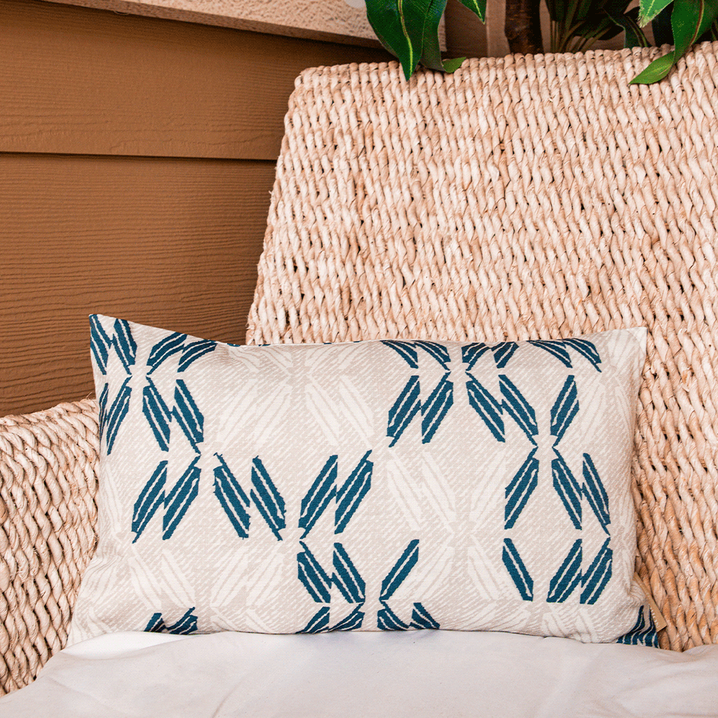 Navy & Ivory Peʻa Lumbar Pillowcase on a woven chair