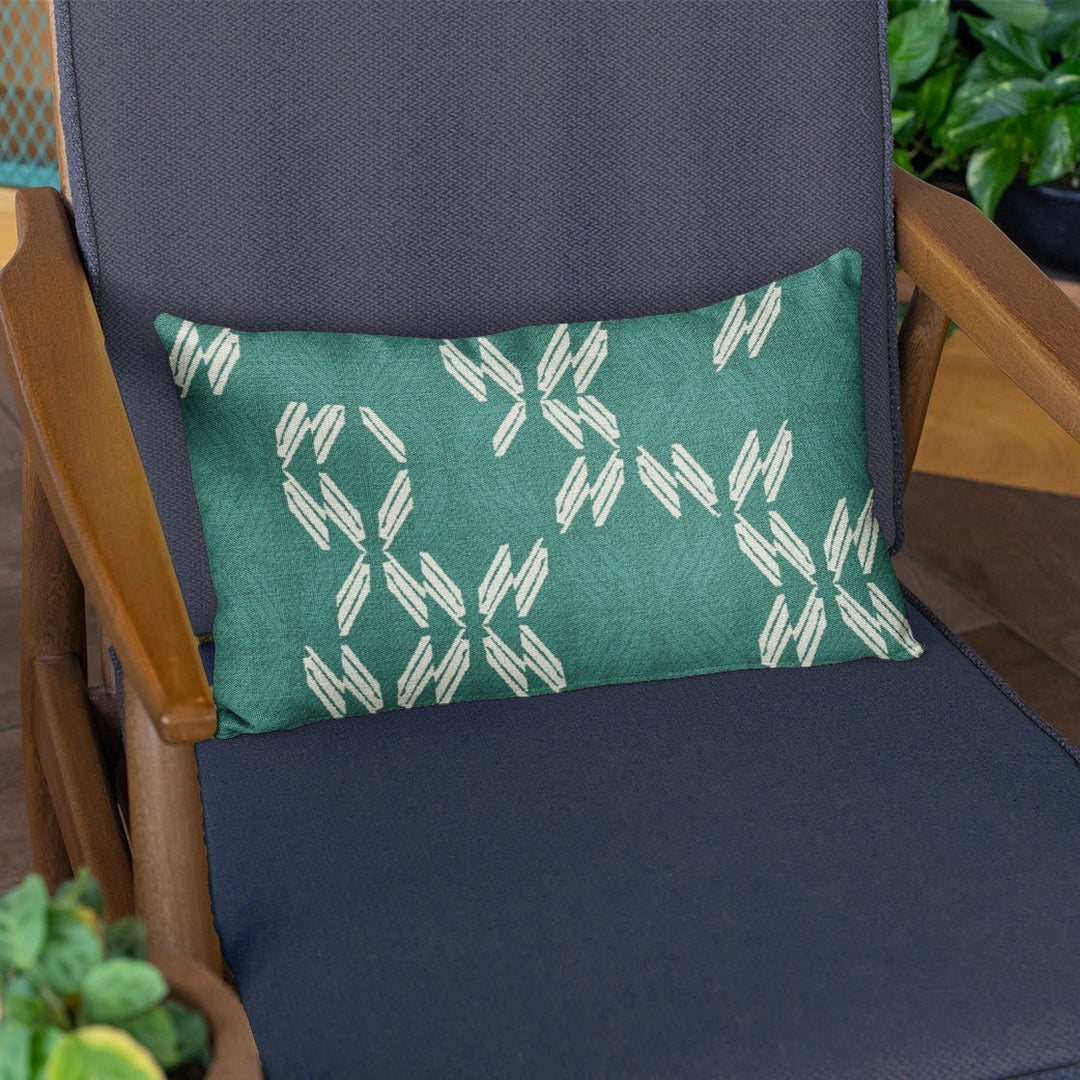 Green Flash  Peʻa Lumbar Pillowcase on a navy chair