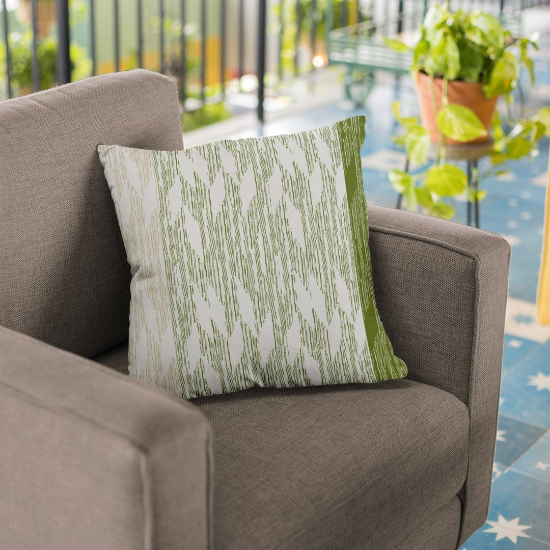 Sage and Ivory Pili Square Pillowcase on a brown chair on a lanai